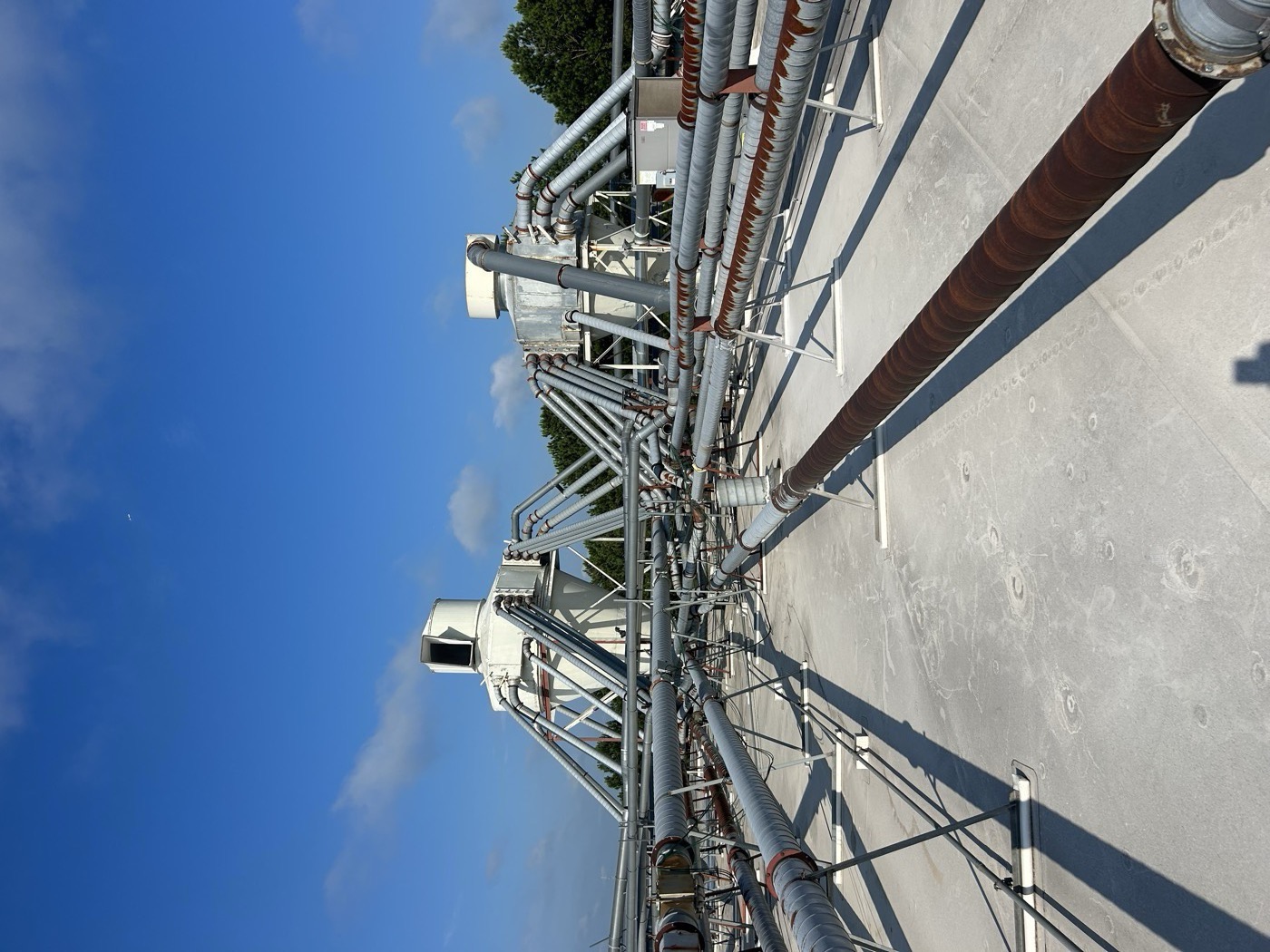 Rooftop induced-draft ventilation fans and piping